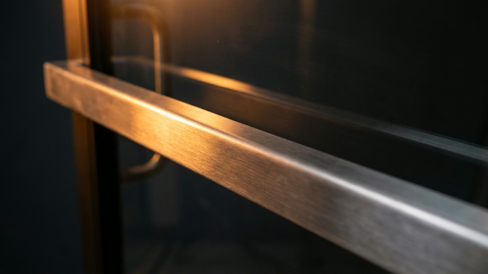 A stainless steel push bar on a commercial door, commercial locksmith service