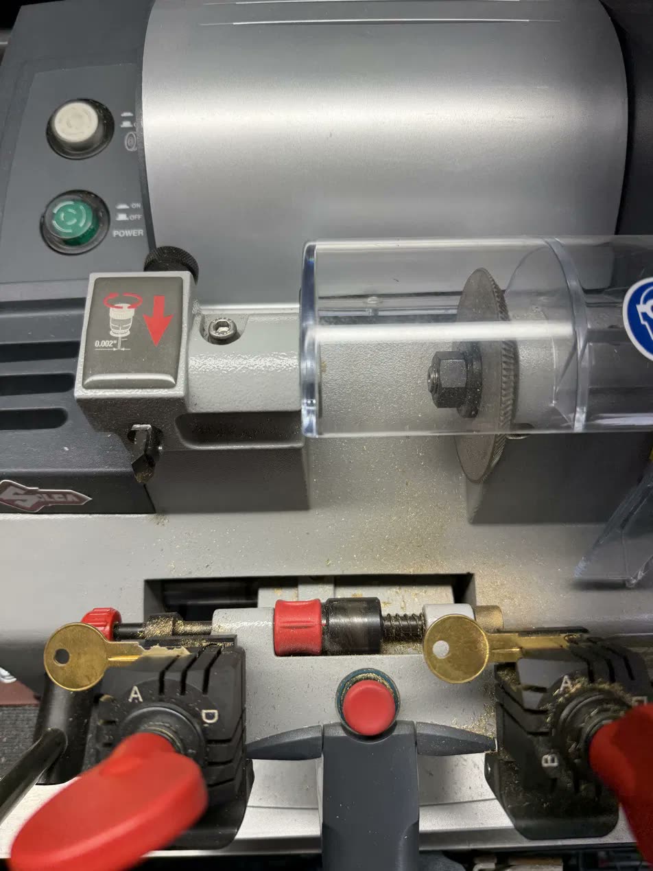 Brass keys clamped in a Silca key cutting machine